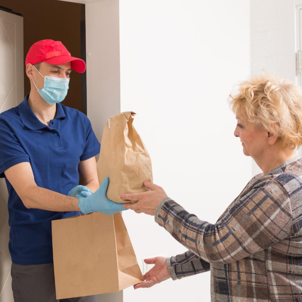 A woman taking prescription delivery from her door